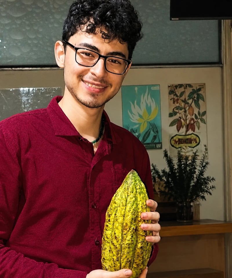 Miguel holding a cacao pod
